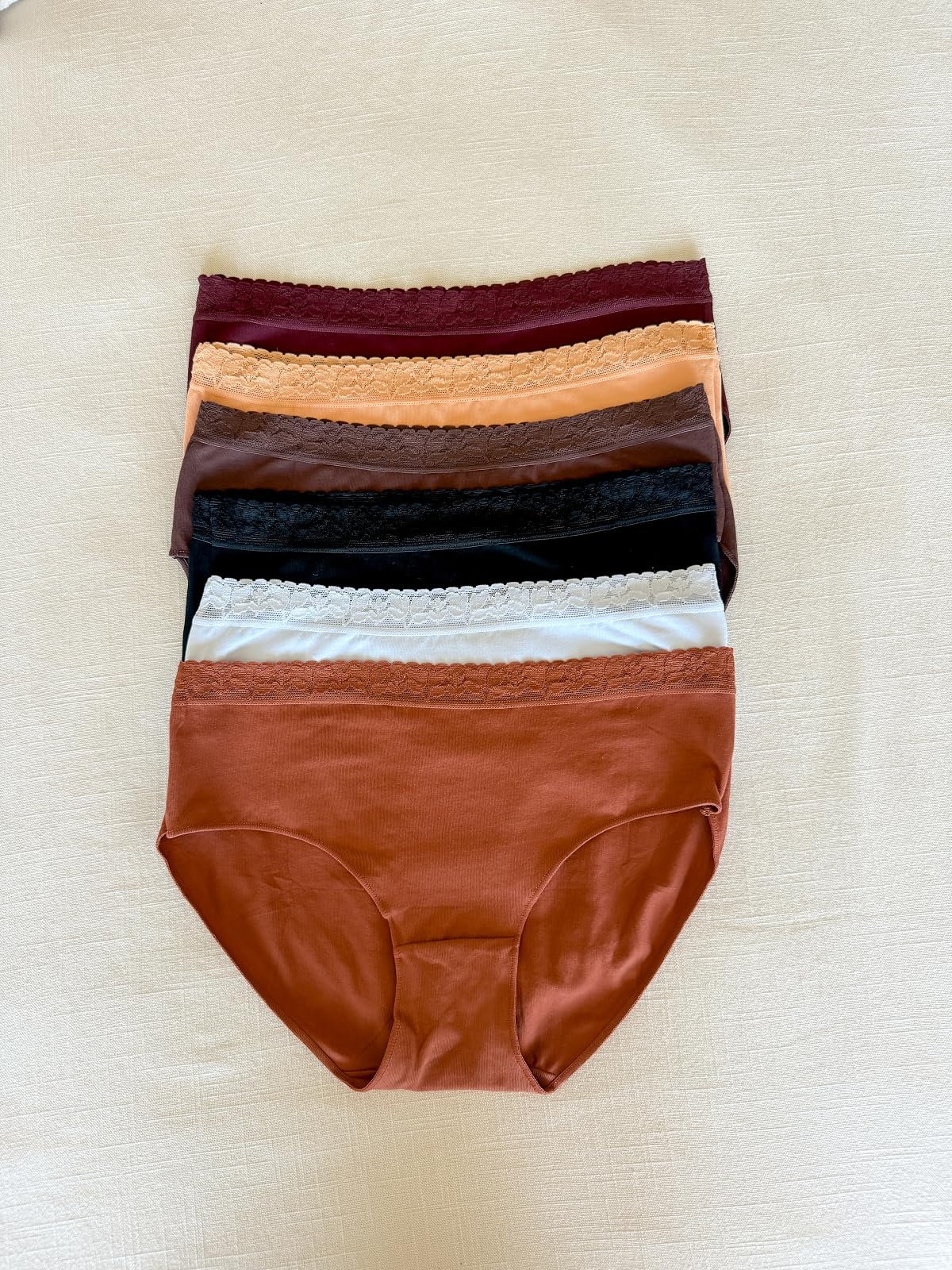 Soft cotton bikini underwear with lace trim in assorted colors, comfortable everyday underwear essentials for women.