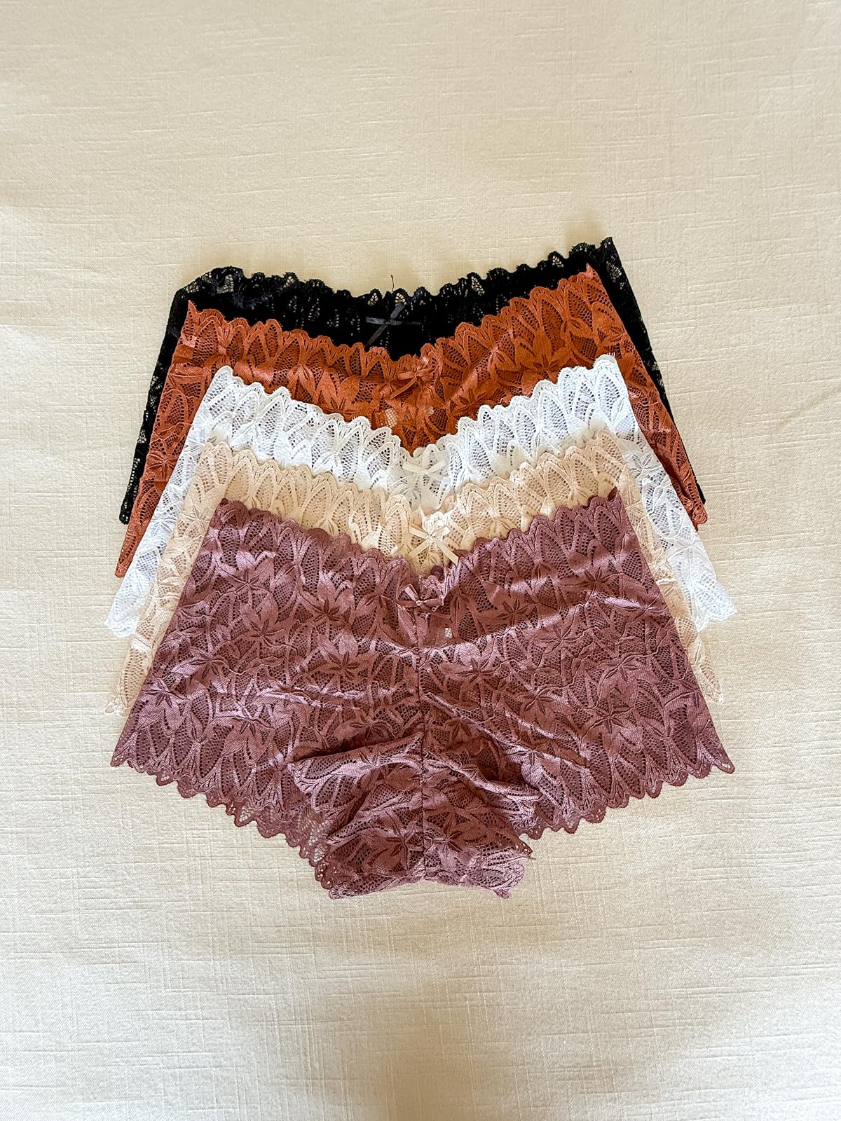 Colorful collection of floral lace boyshort underwear in neutral and seasonal shades, offering comfortable coverage and a feminine design.