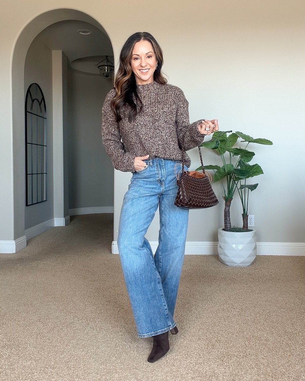 Holly styling high-rise relaxed wide-leg Banana Republic jeans with a cozy brown knit sweater, brown ankle boots, and a matching handbag for fall.