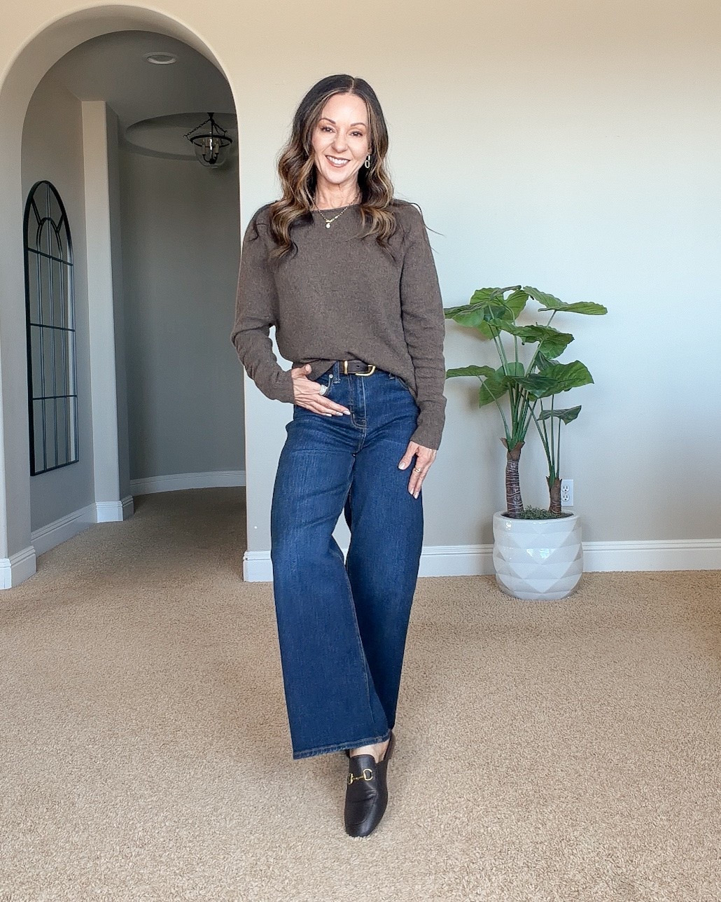 Holly wearing Quince wide-leg jeans in a dark blue wash with a gray cashmere sweater and black ankle boots, featuring a classic fall denim outfit.
